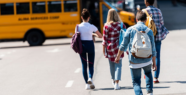 Image of teens walking to community supported transportation.