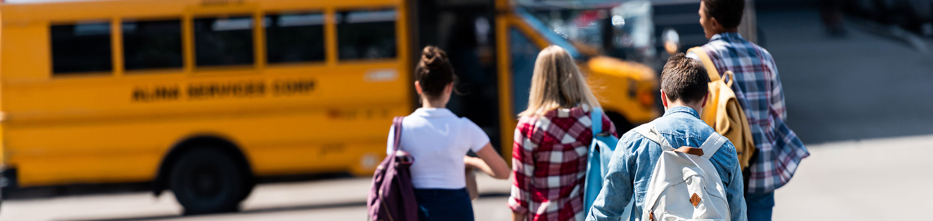 Image of teens walking toward community transportation van.
